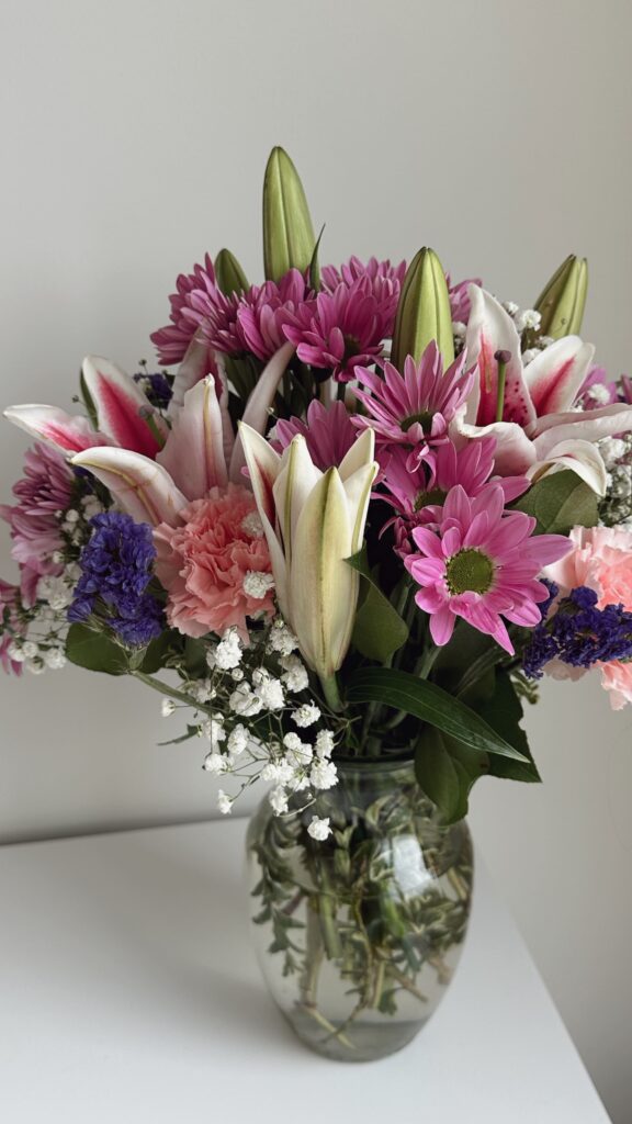 Mixed spring flowers in a short vase